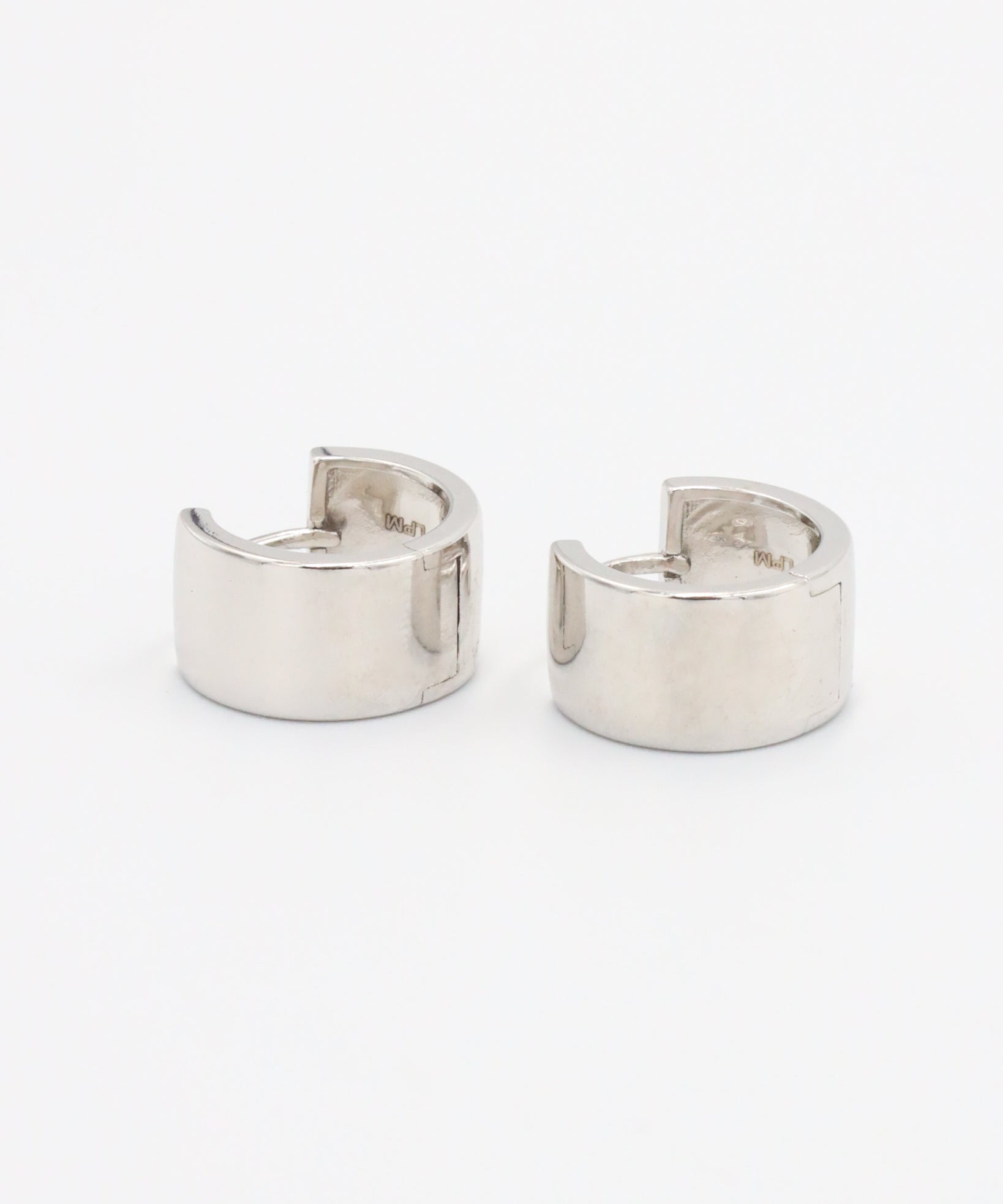 A single silver hoop earring with a hinged clasp, displayed against a white background.