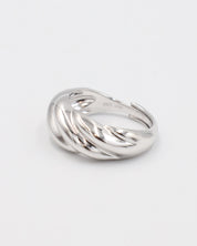 A silver-colored ring with a twisted design on a white background.