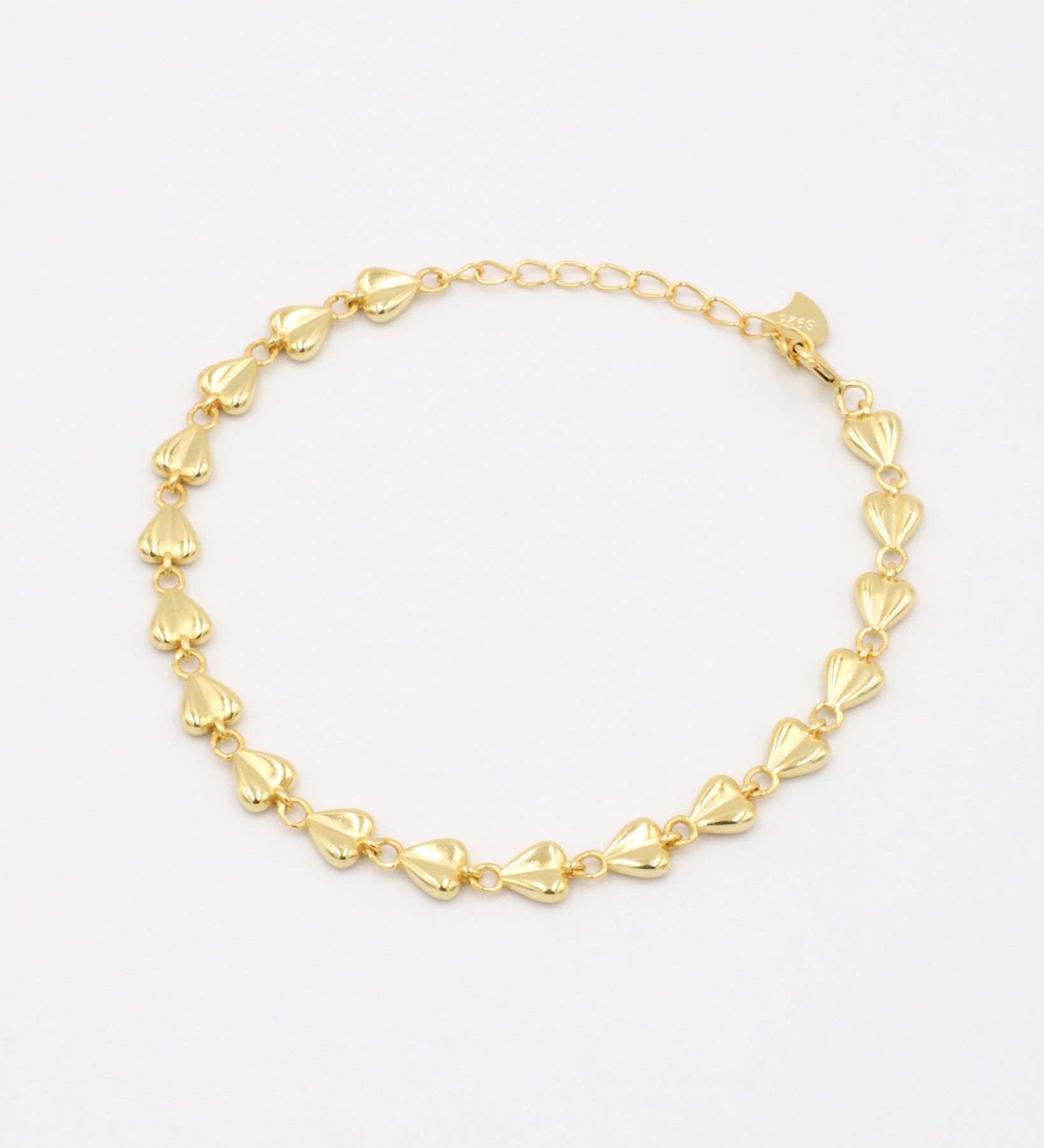 A gold-colored bracelet with a chain link design on a white background