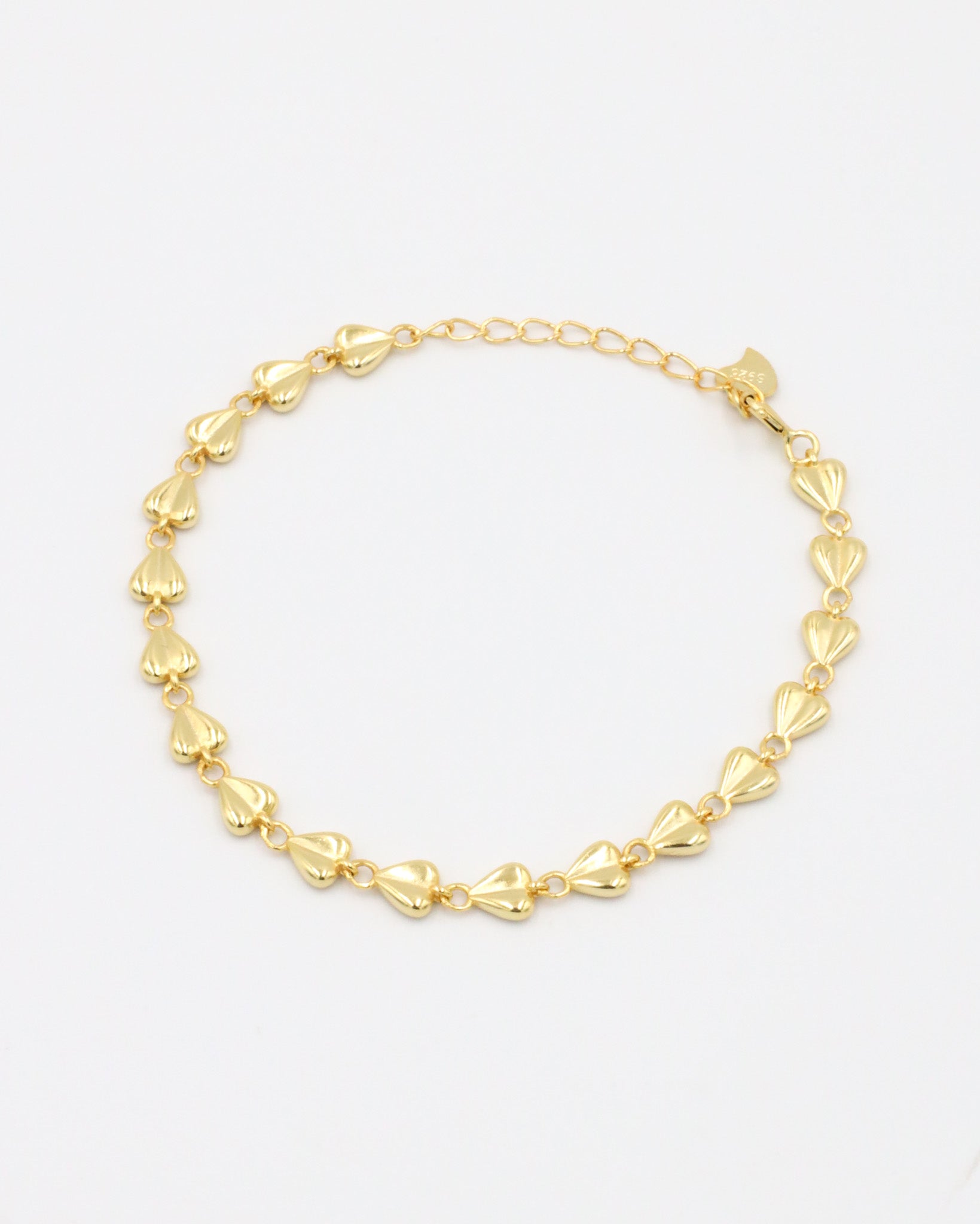 A gold-colored bracelet with a chain link design on a white background
