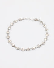 A silver bracelet with a heart-shaped pattern on a white background
