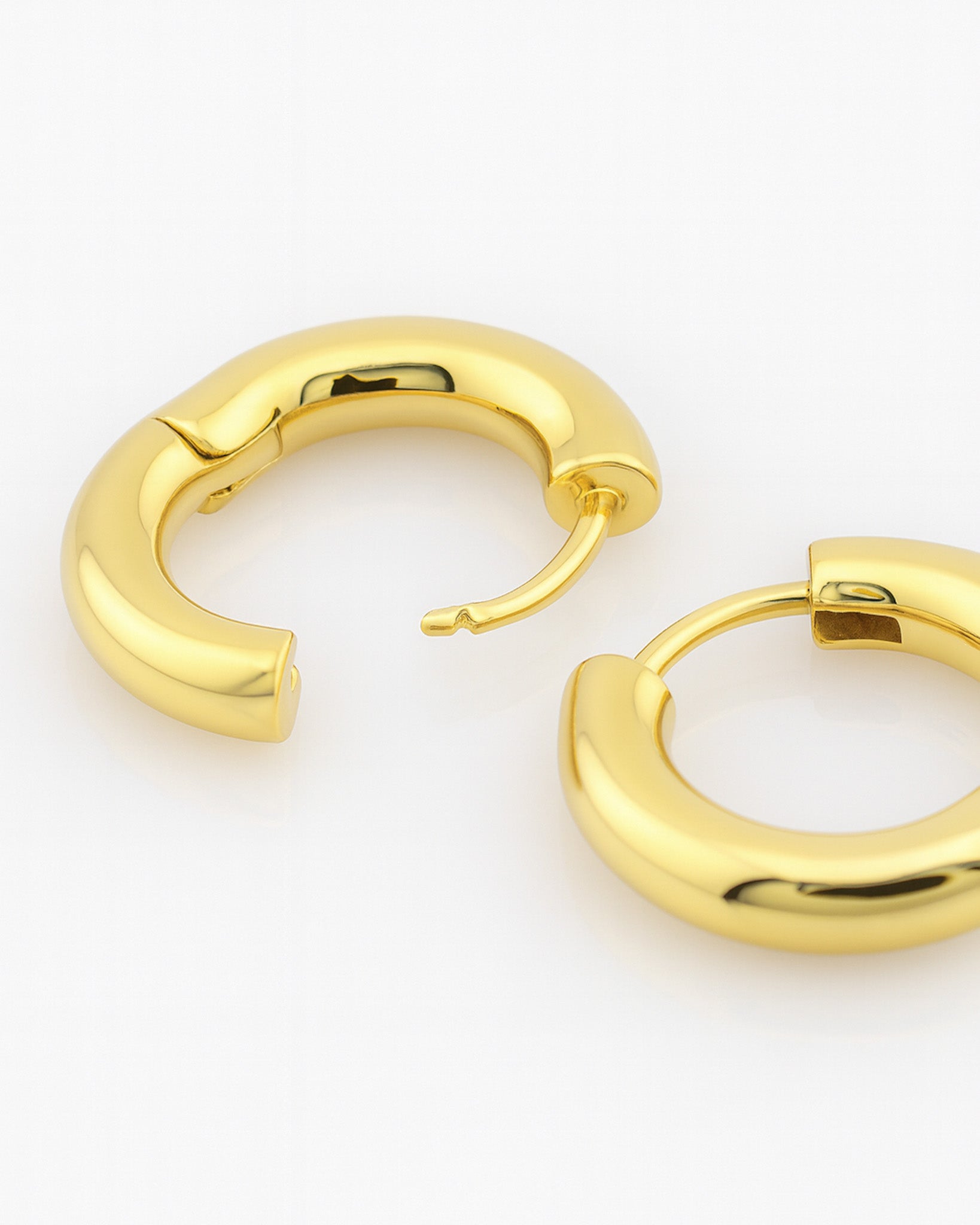Gold hoop earrings on a white background
