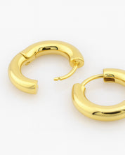 Gold hoop earrings on a white background