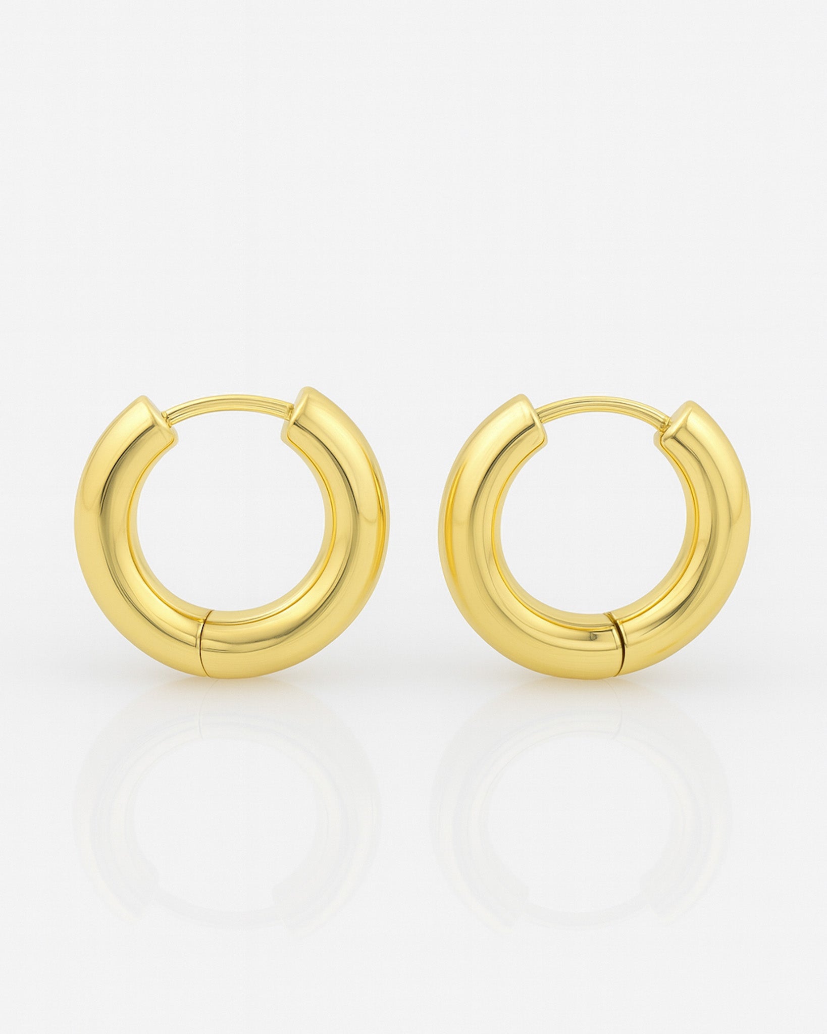 Gold hoop earrings on a white background