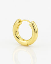 Gold hoop earring on a white background