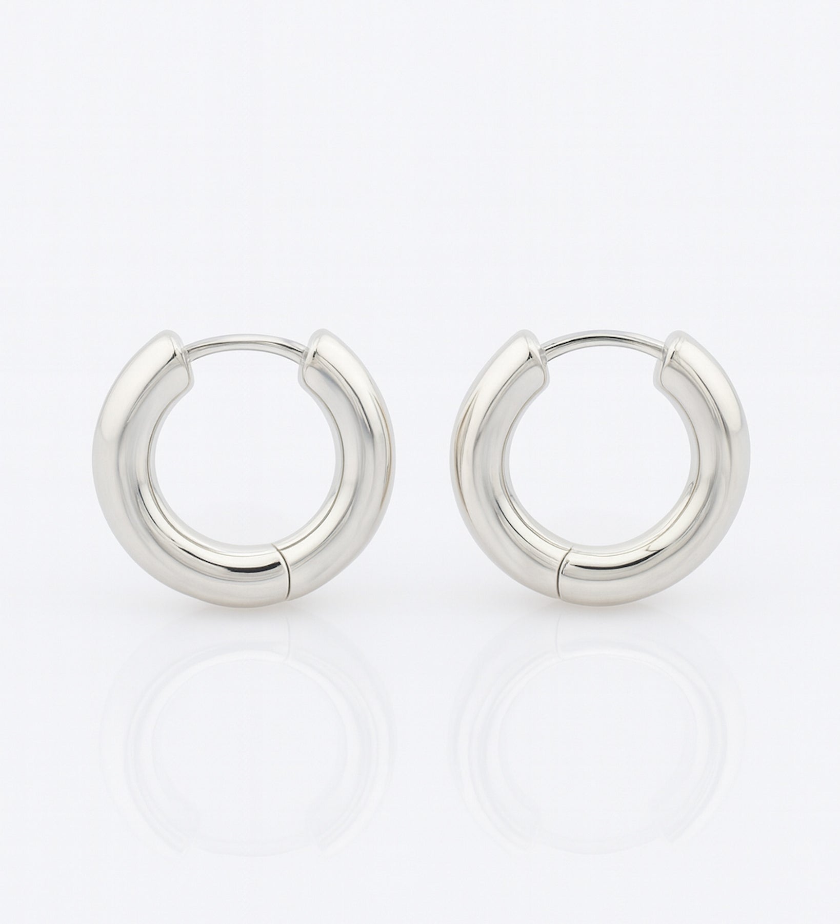 Pair of silver hoop earrings on a white background