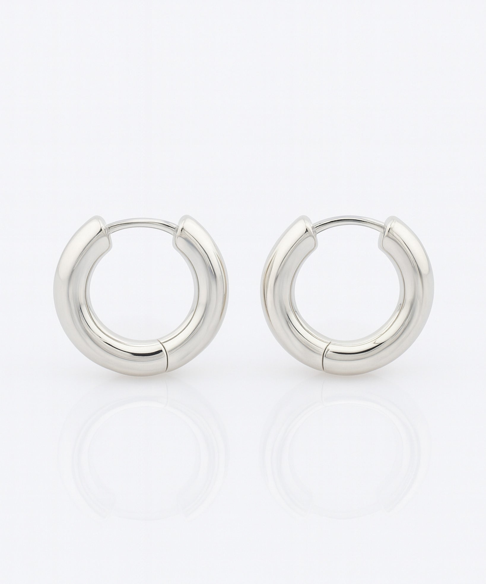 Pair of silver hoop earrings on a white background