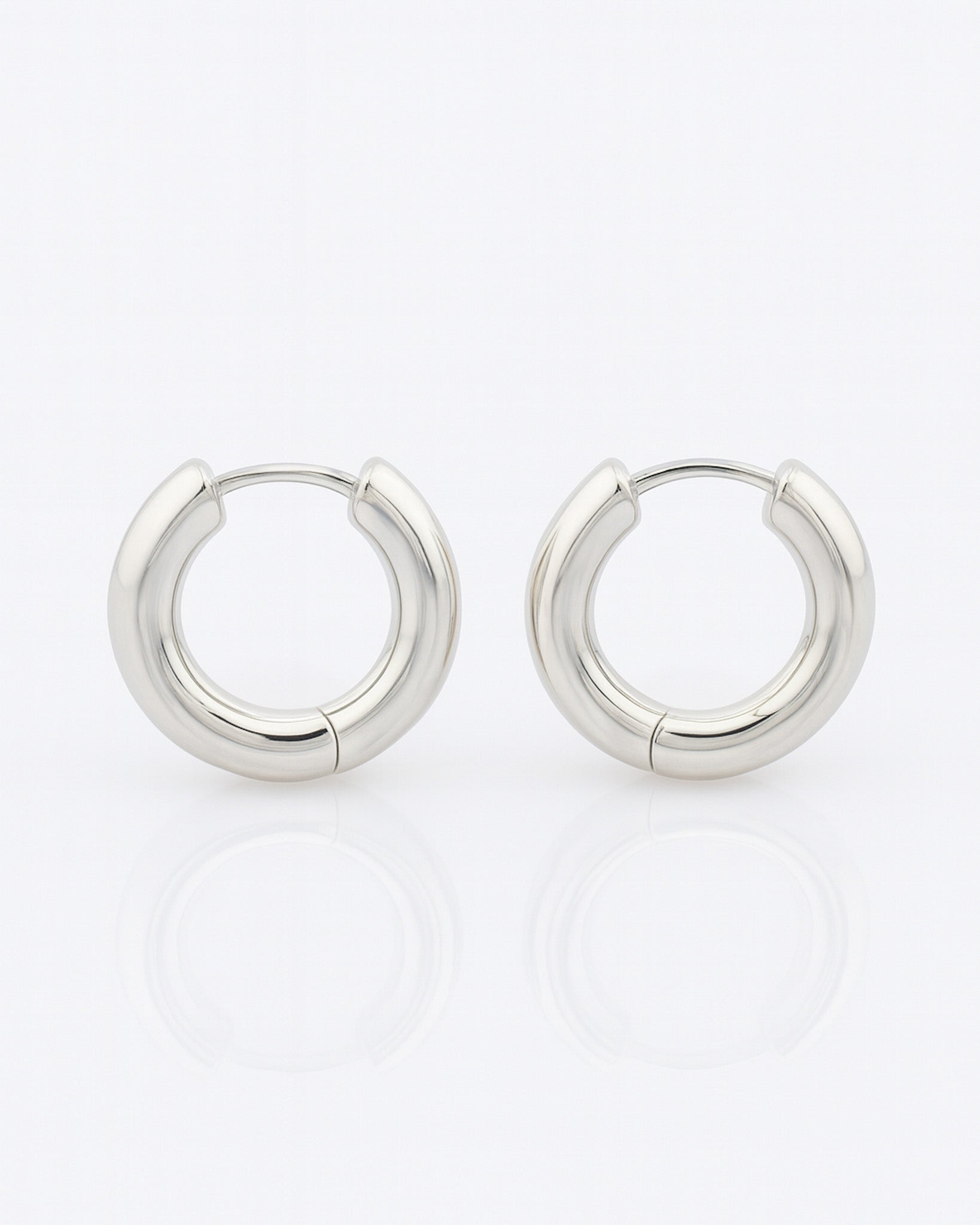 Pair of silver hoop earrings on a white background