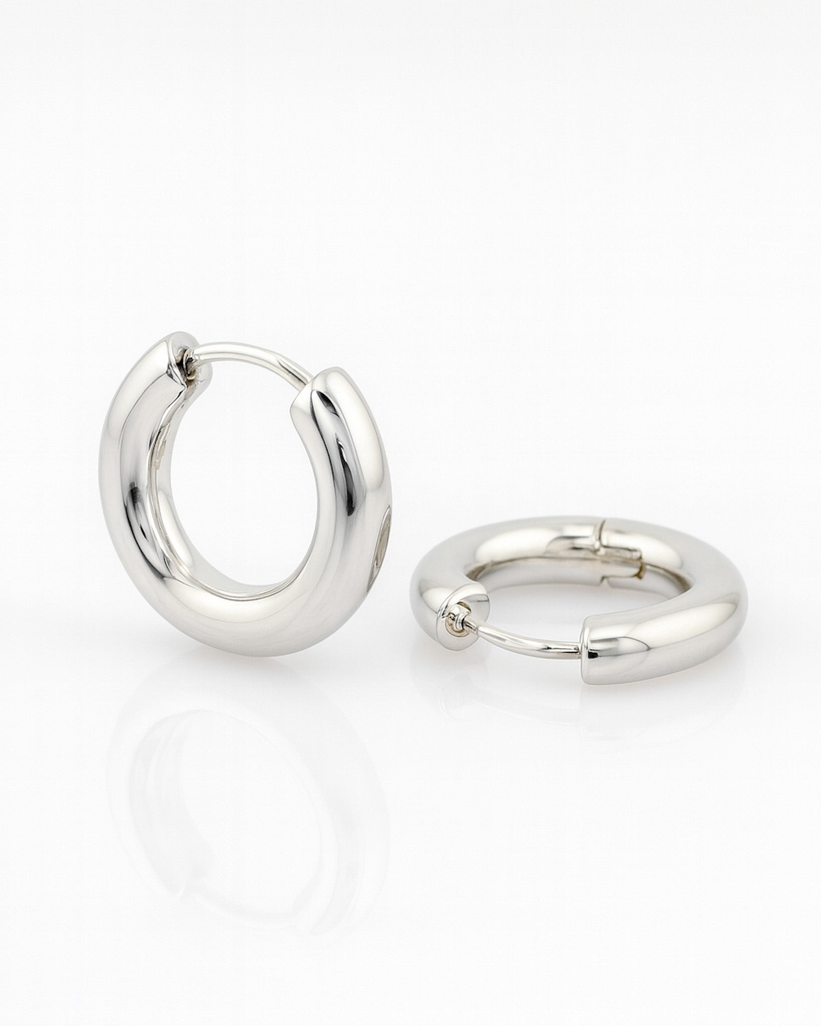 Pair of silver hoop earrings on a white background