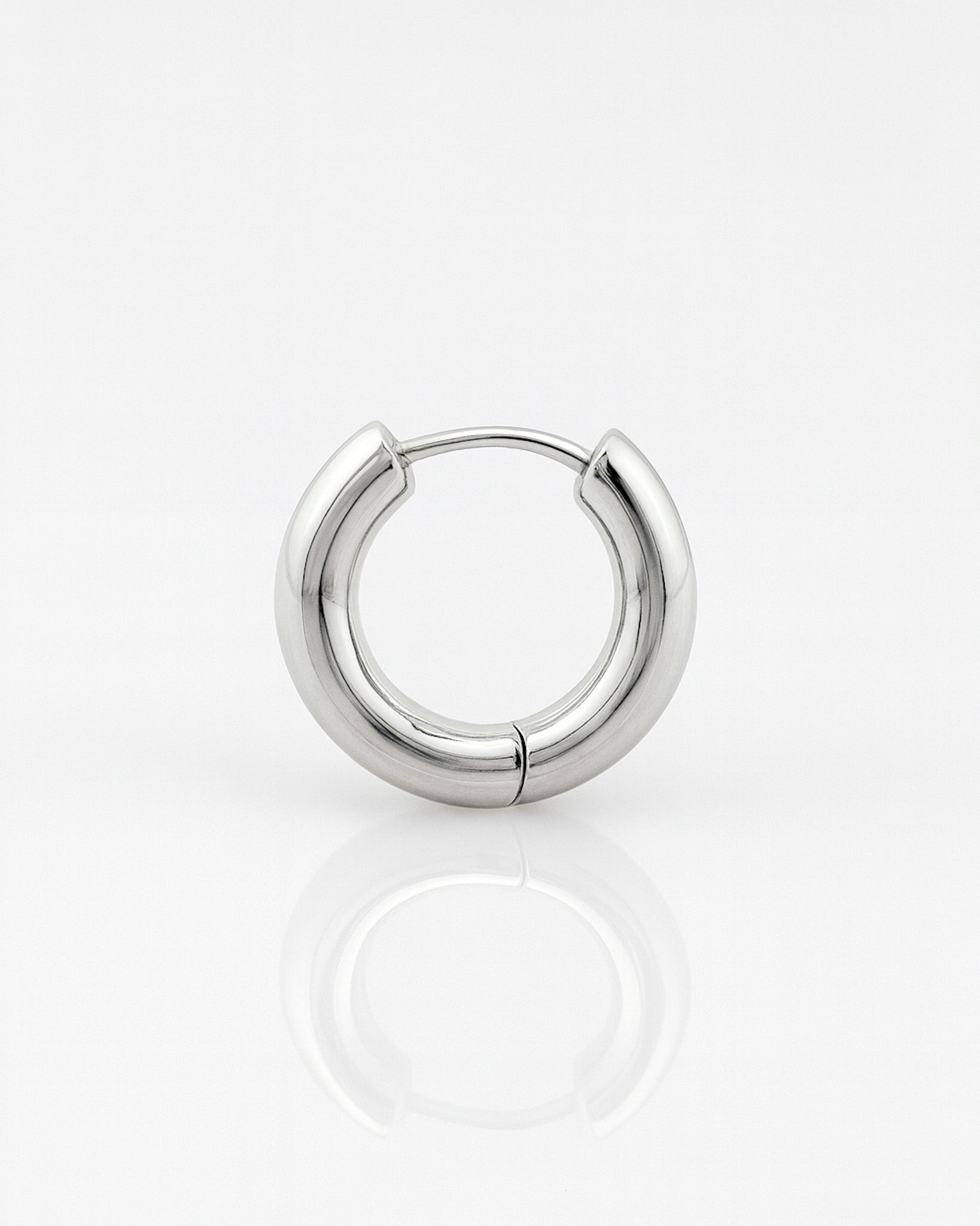 Silver hoop earring on a white background