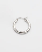 A pair of silver hoop earrings with a latch back closure on a white background