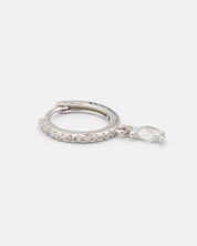 A silver-colored hoop earring with a small dangling gemstone attached, displayed against a white background.