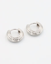 A pair of silver hoop earrings with a hinged clasp closure.