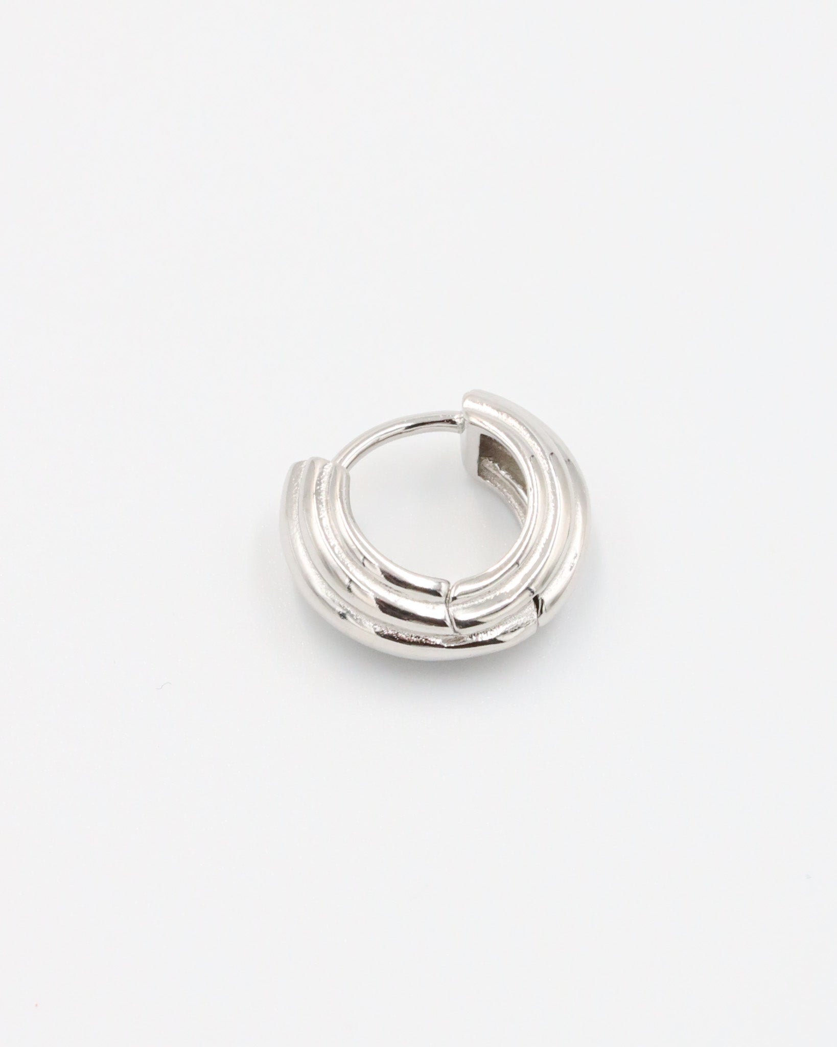 A pair of silver hoop earrings with a hinged clasp closure.