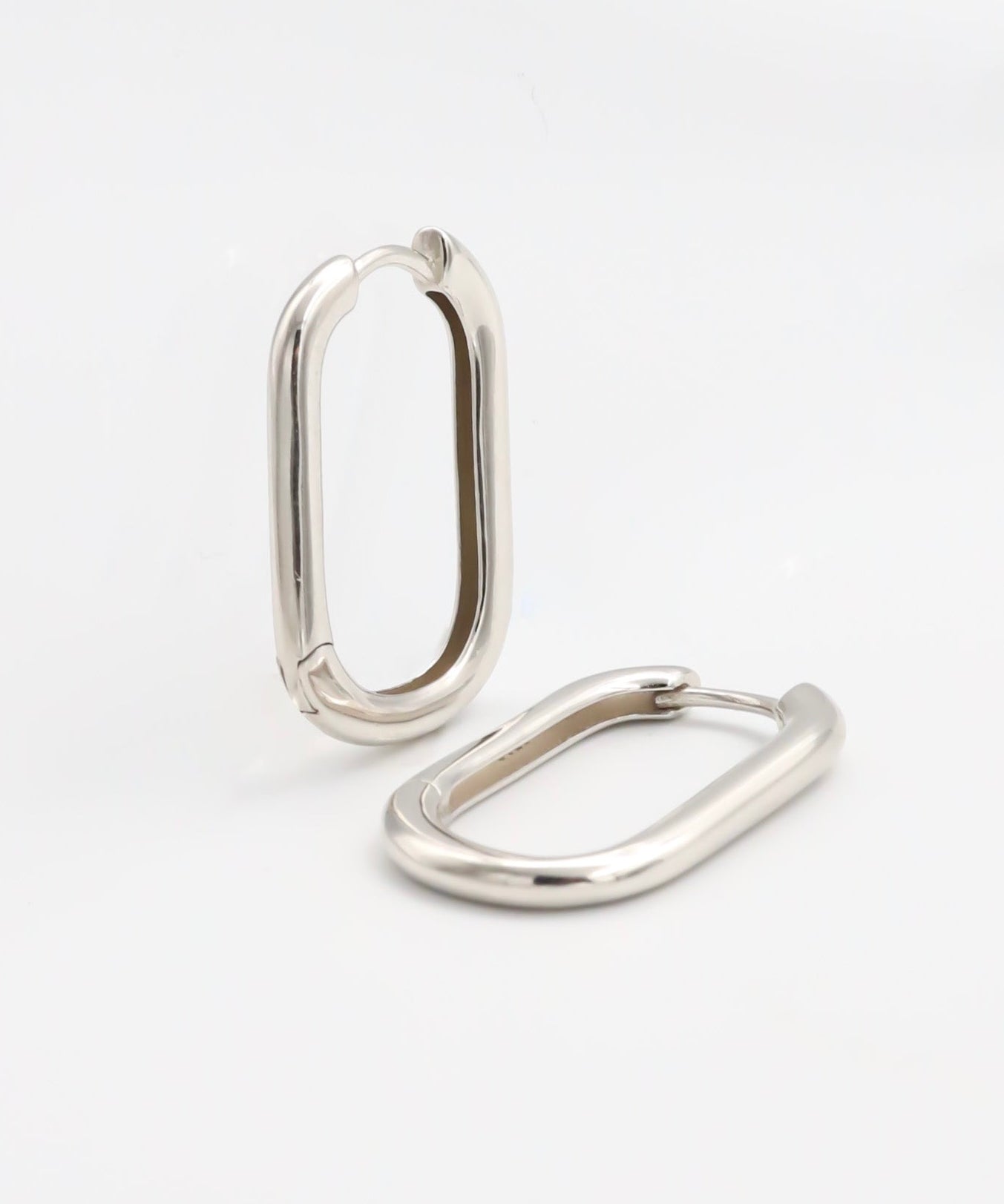 Two silver-colored metal belt buckles with a simple, classic design on a white background.