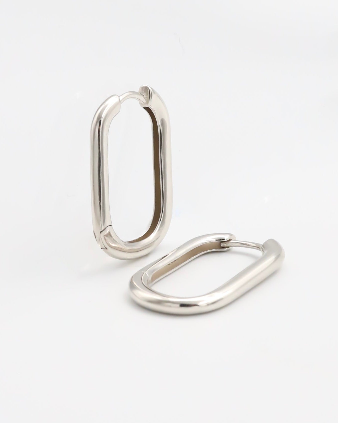 Two silver-colored metal belt buckles with a simple, classic design on a white background.