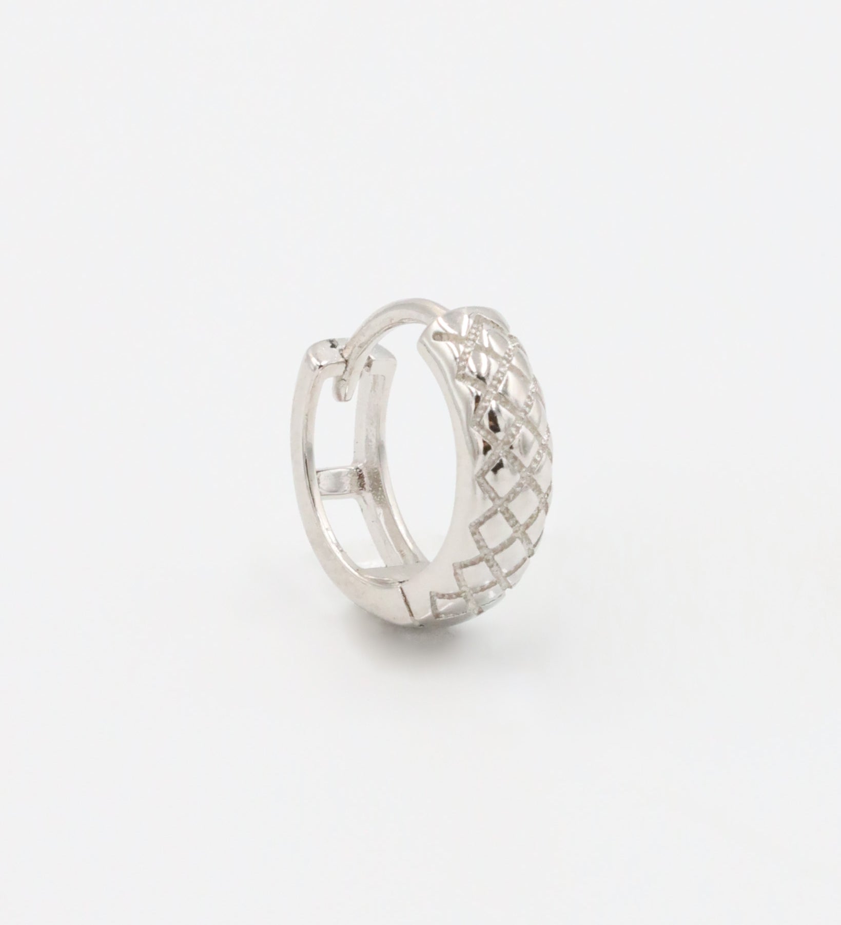 A single silver hoop earring with a geometric pattern and a hinged clasp.