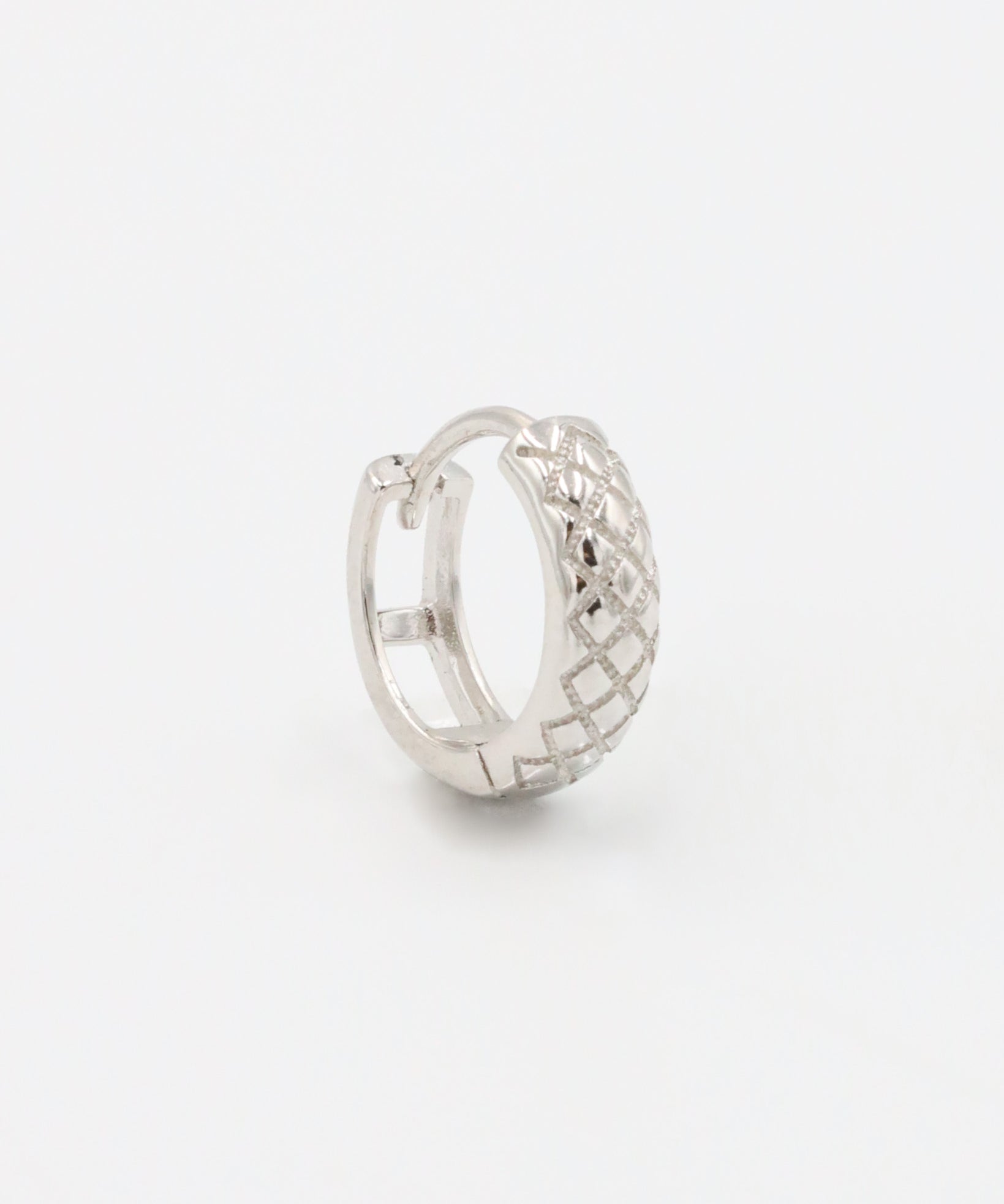 A single silver hoop earring with a geometric pattern and a hinged clasp.