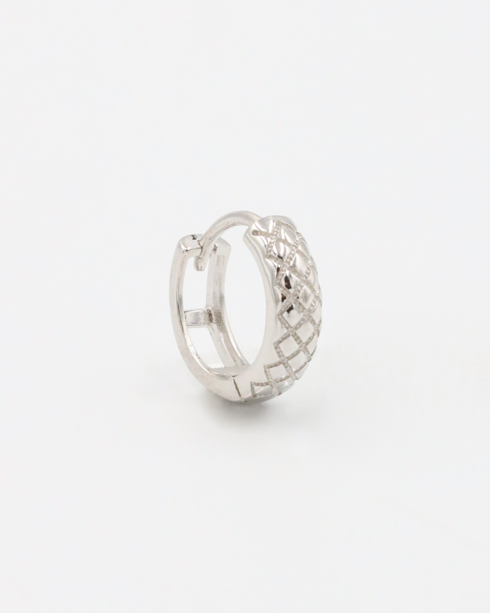 A single silver hoop earring with a geometric pattern and a hinged clasp.