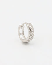 A single silver hoop earring with a geometric pattern and a hinged clasp.