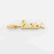 Gold 'Liebi' pendant on a white background