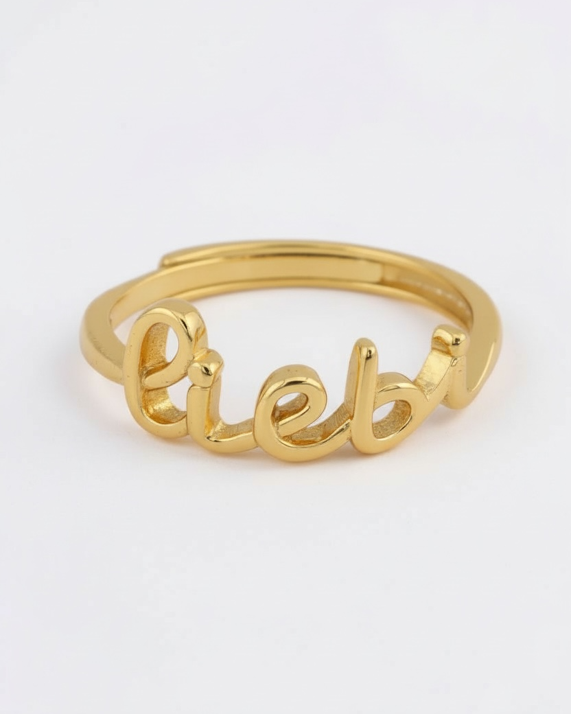 Gold ring with 'liebe' engraving on a white background