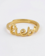 Gold ring with 'liebe' engraving on a white background