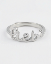 Silver ring with 'Lieb' engraving on a white background