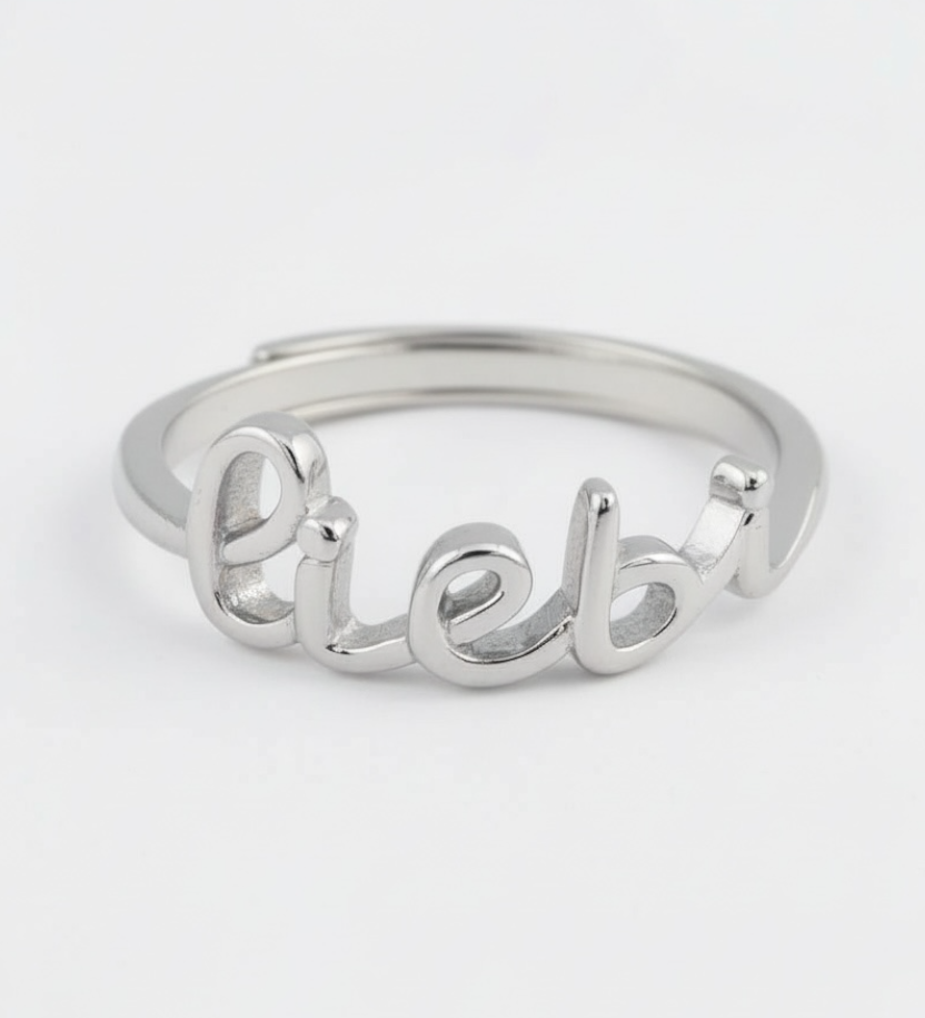 Silver ring with 'Lieb' engraving on a white background