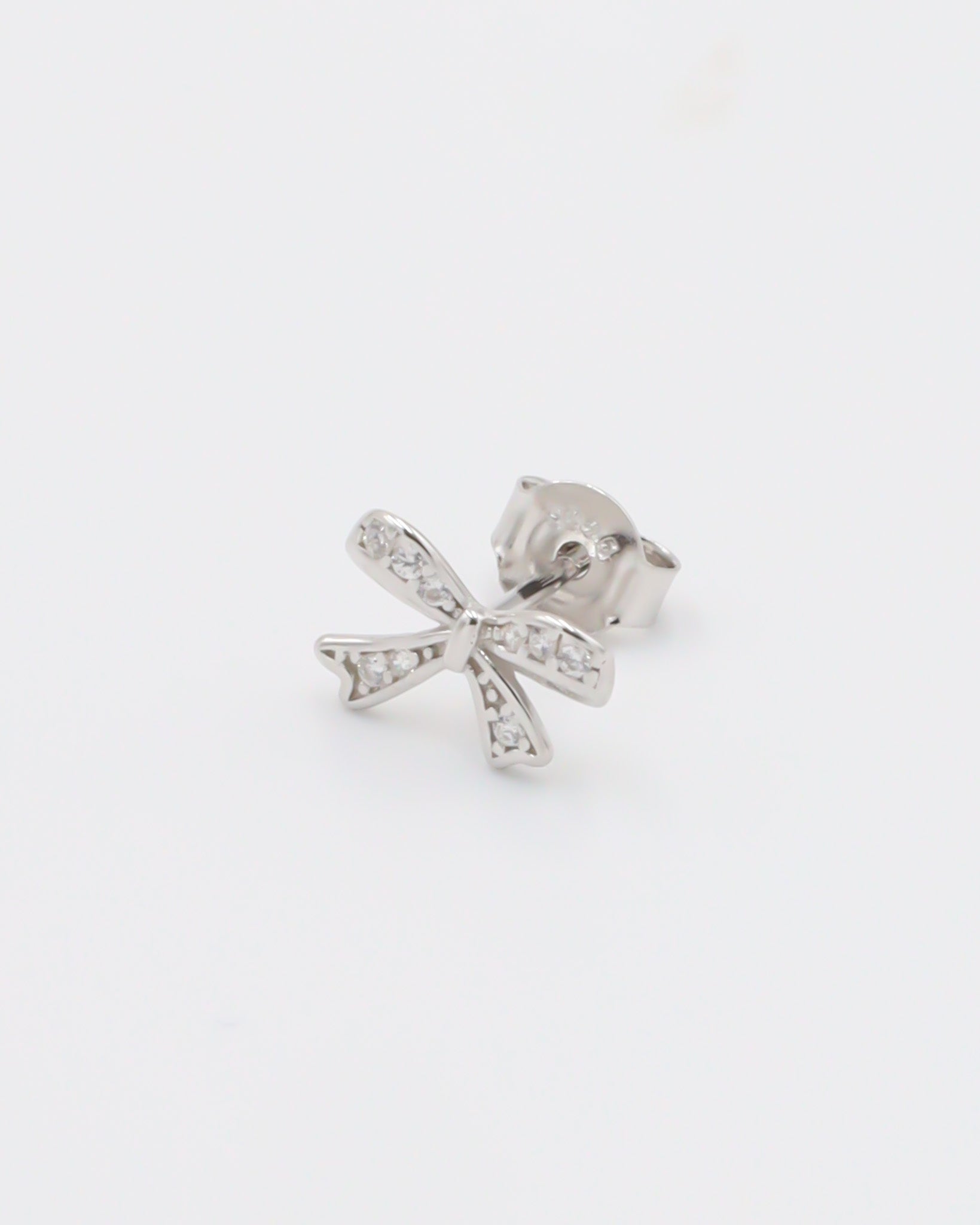 A pair of silver hoop earrings with butterfly closures and small clear embellishments, displayed against a white background.