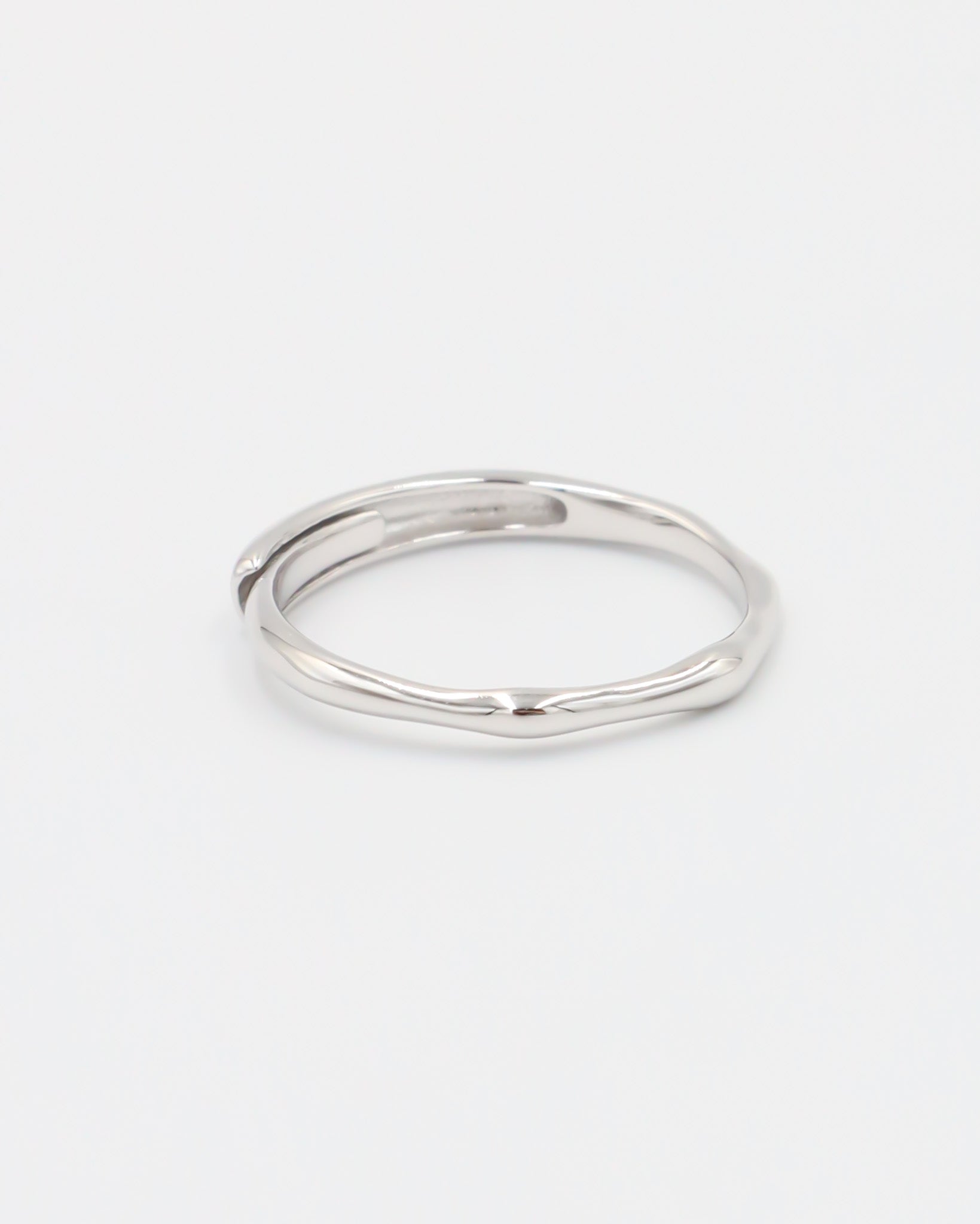 A silver ring on a white background.