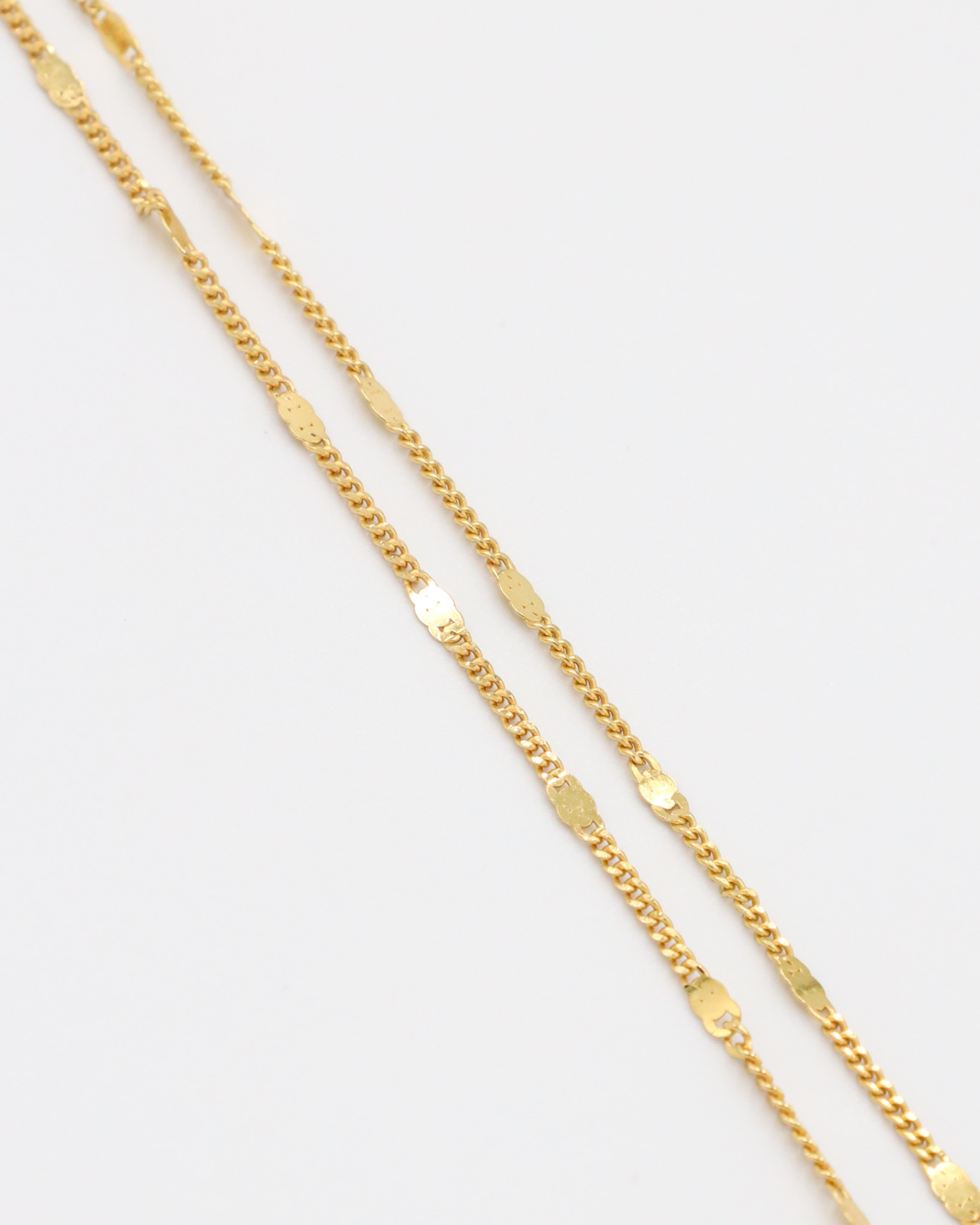 Close-up view of the detailed links on the gold-plated Loretta Necklace.