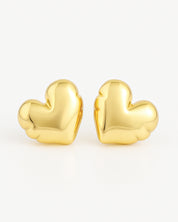 Gold heart-shaped earrings on a white background