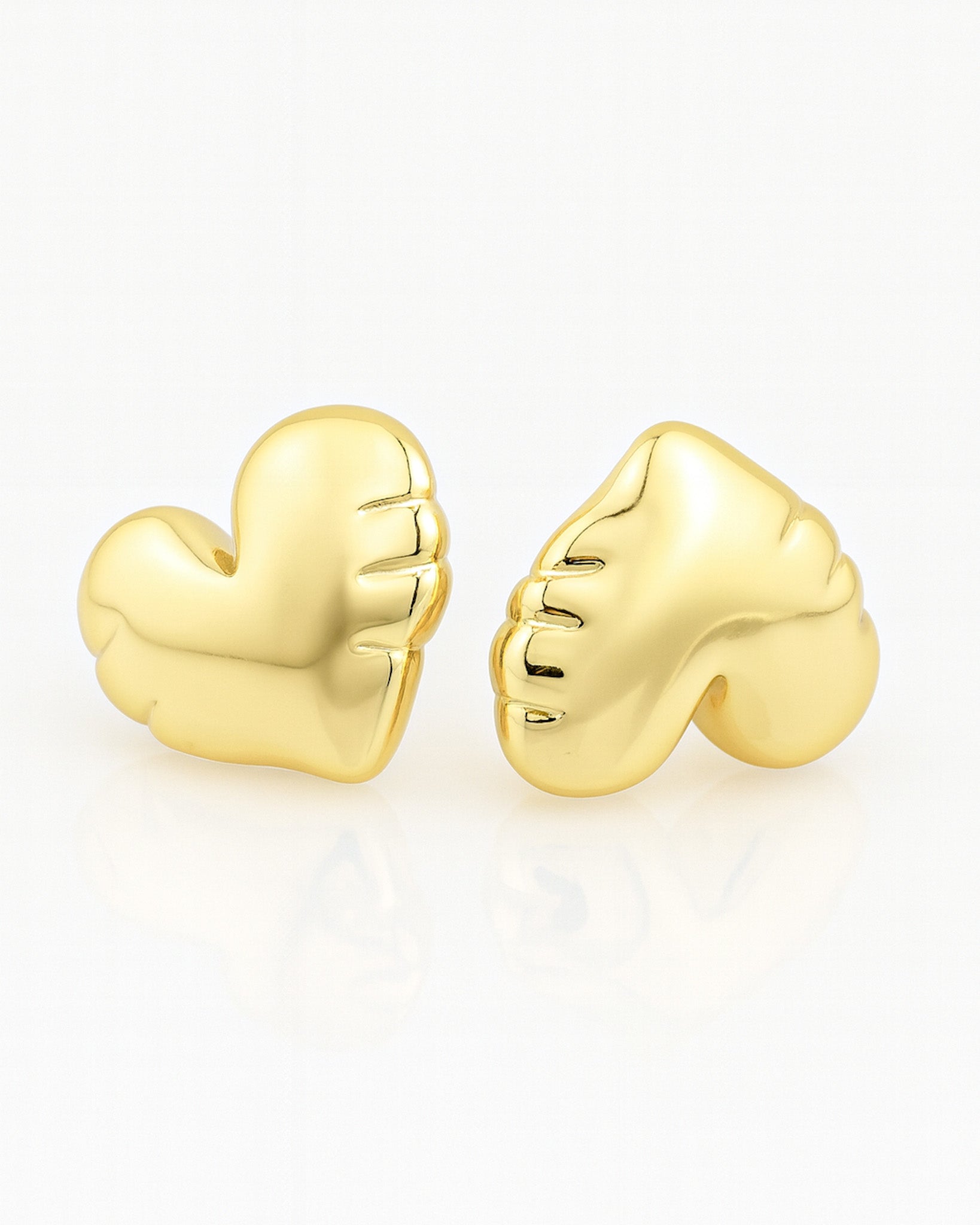 Gold heart-shaped earrings on a white background
