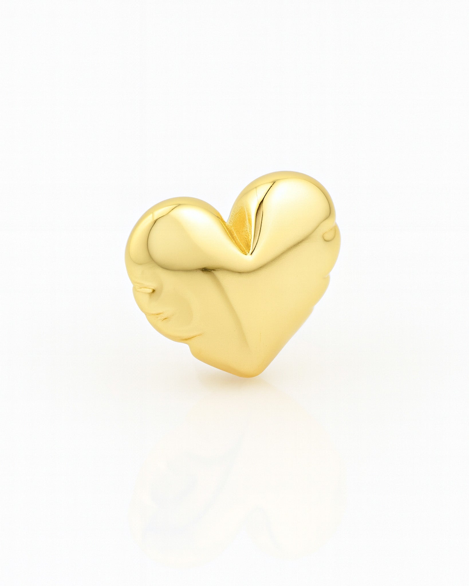 Gold heart-shaped charm on a white background