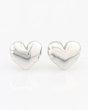 Heart-shaped silver earrings on a white background