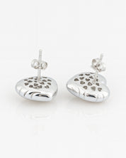 Pair of silver heart-shaped earrings with cut-out heart designs on a white background