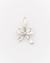 Silver bow-shaped pendant on a white background