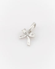 Silver bow-shaped pendant on a white background
