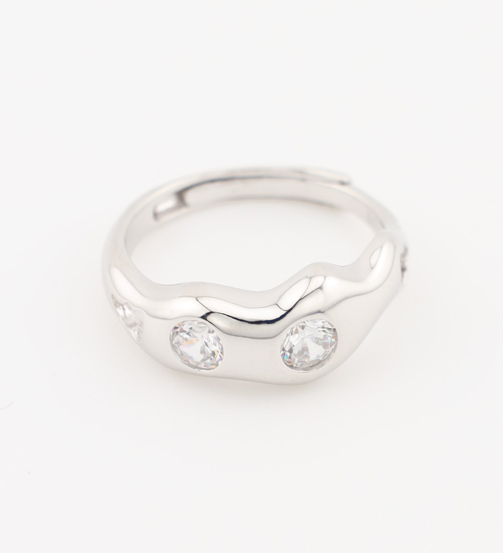 Silver ring with two clear gemstones on a white background