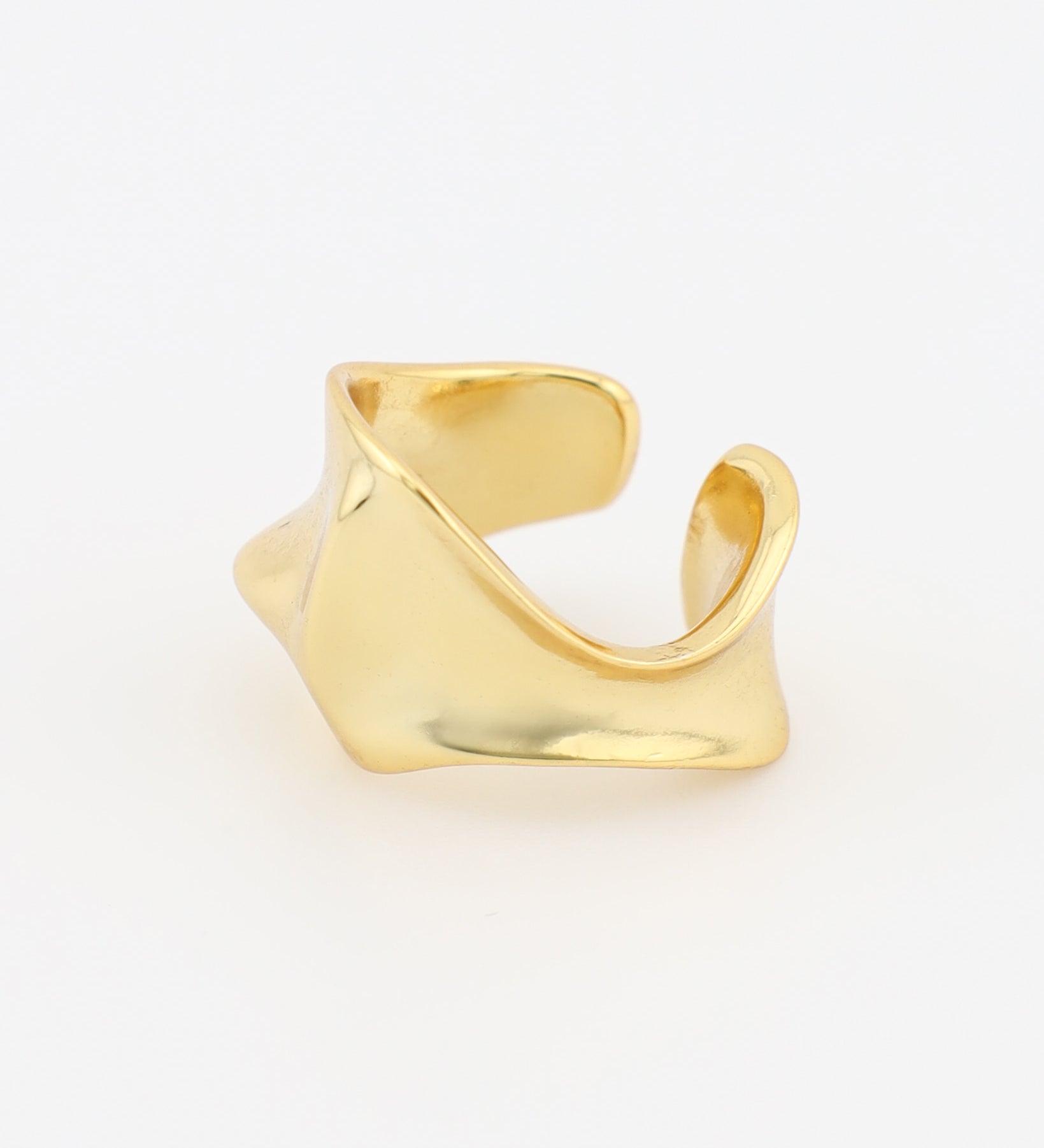 Gold Ear Cuff on a light beige background