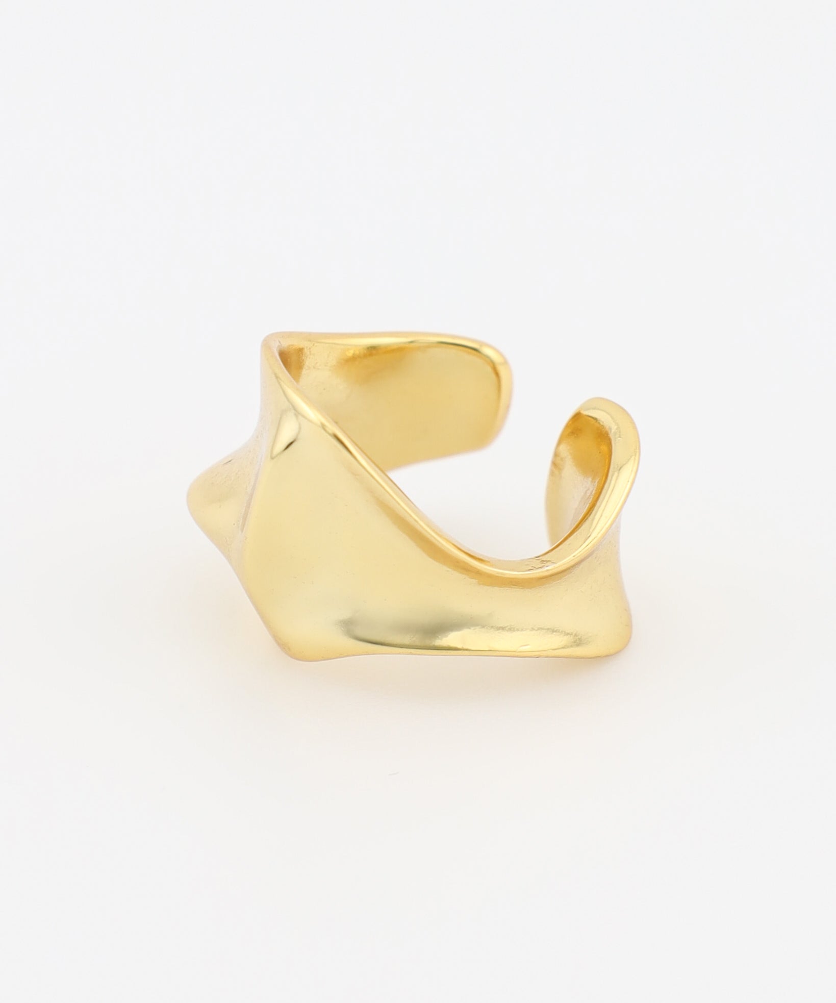 Gold Ear Cuff on a light beige background