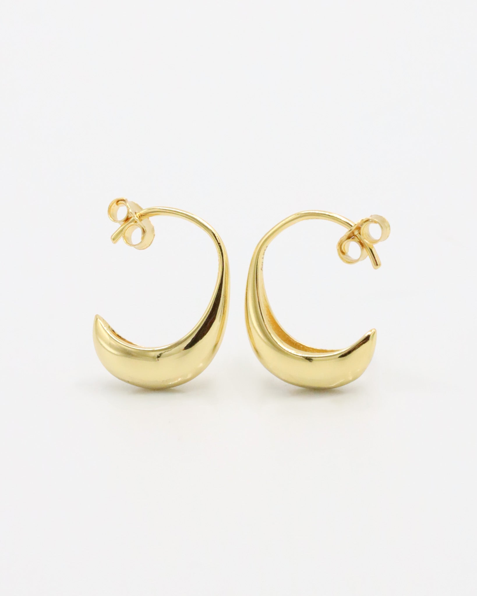 A pair of small gold-colored hoop earrings with a modern design.