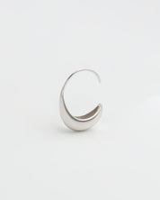 A pair of silver-colored hoop earrings on a white background
