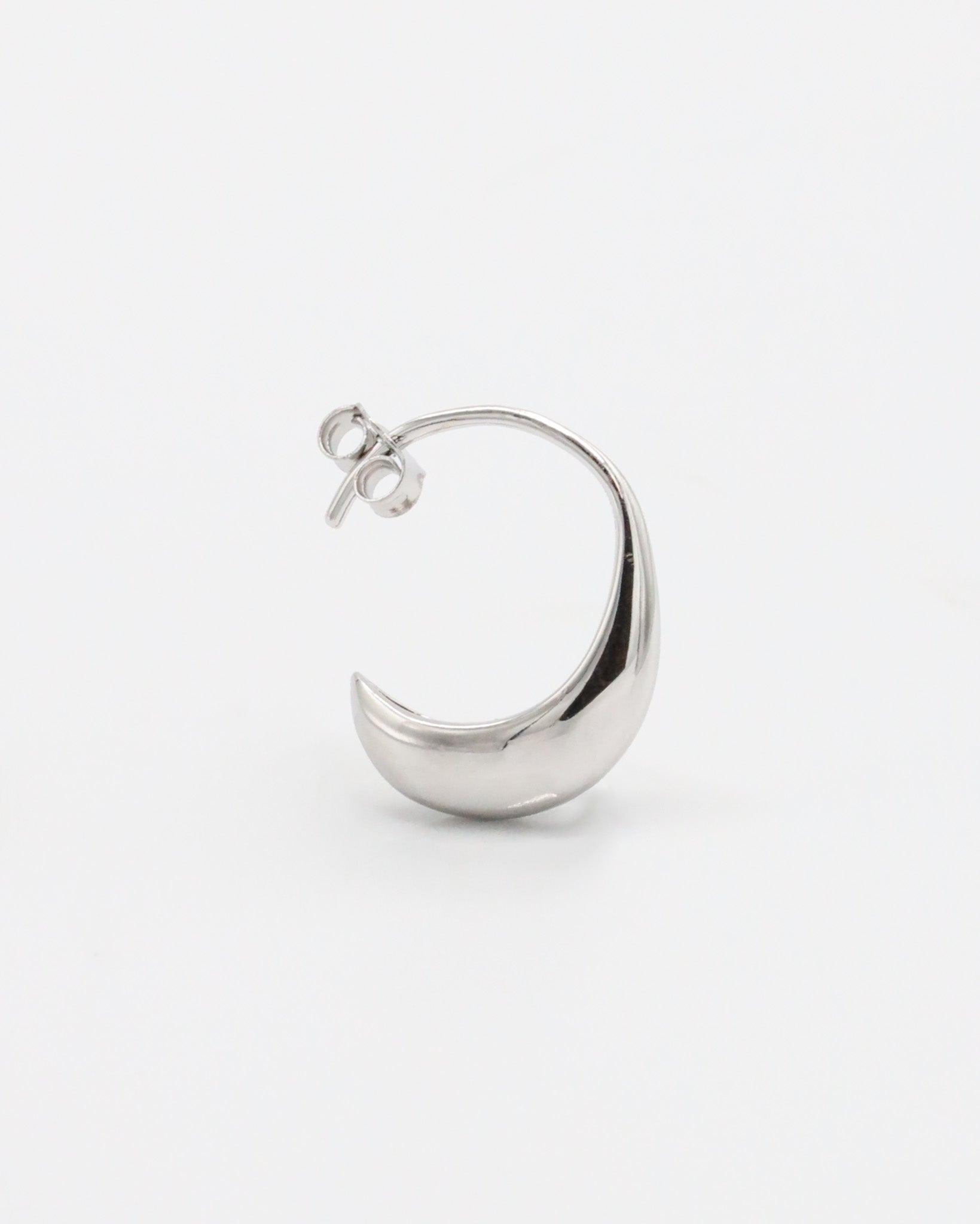 A pair of small silver hoop earrings with a textured surface on a white background.