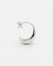 A pair of small silver hoop earrings with a textured surface on a white background.