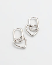 A pair of silver hoop earrings with a hinged clasp mechanism on a white background.