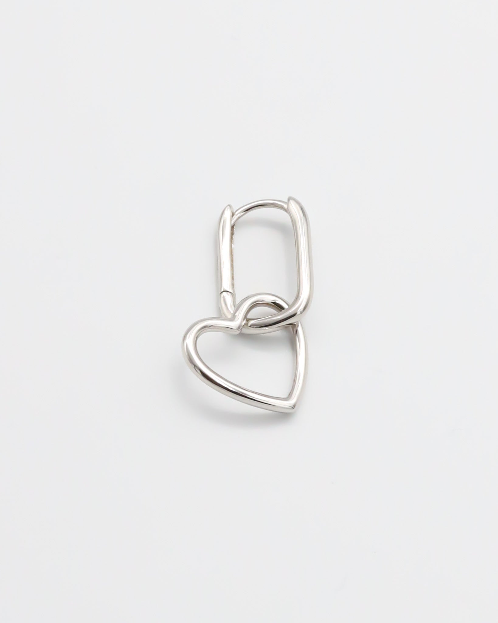 A single silver hoop earring with a hinged clasp mechanism on a white background.