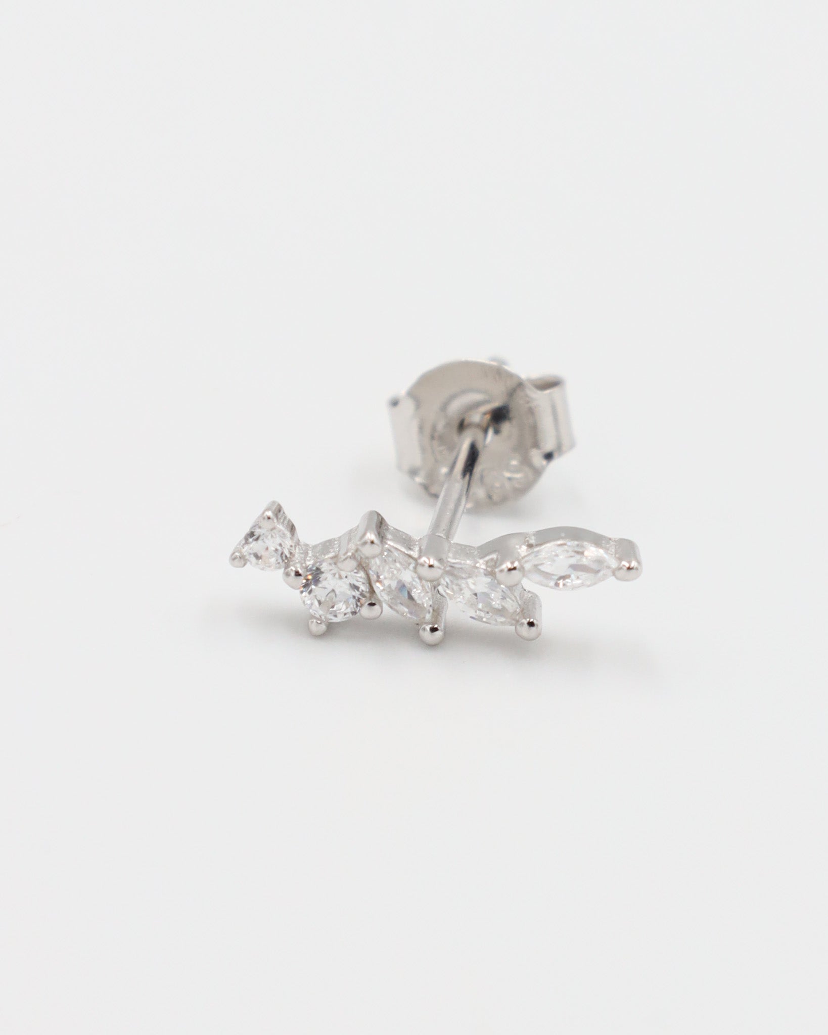 A pair of silver stud earrings with a butterfly clasp, featuring a intricate pattern.