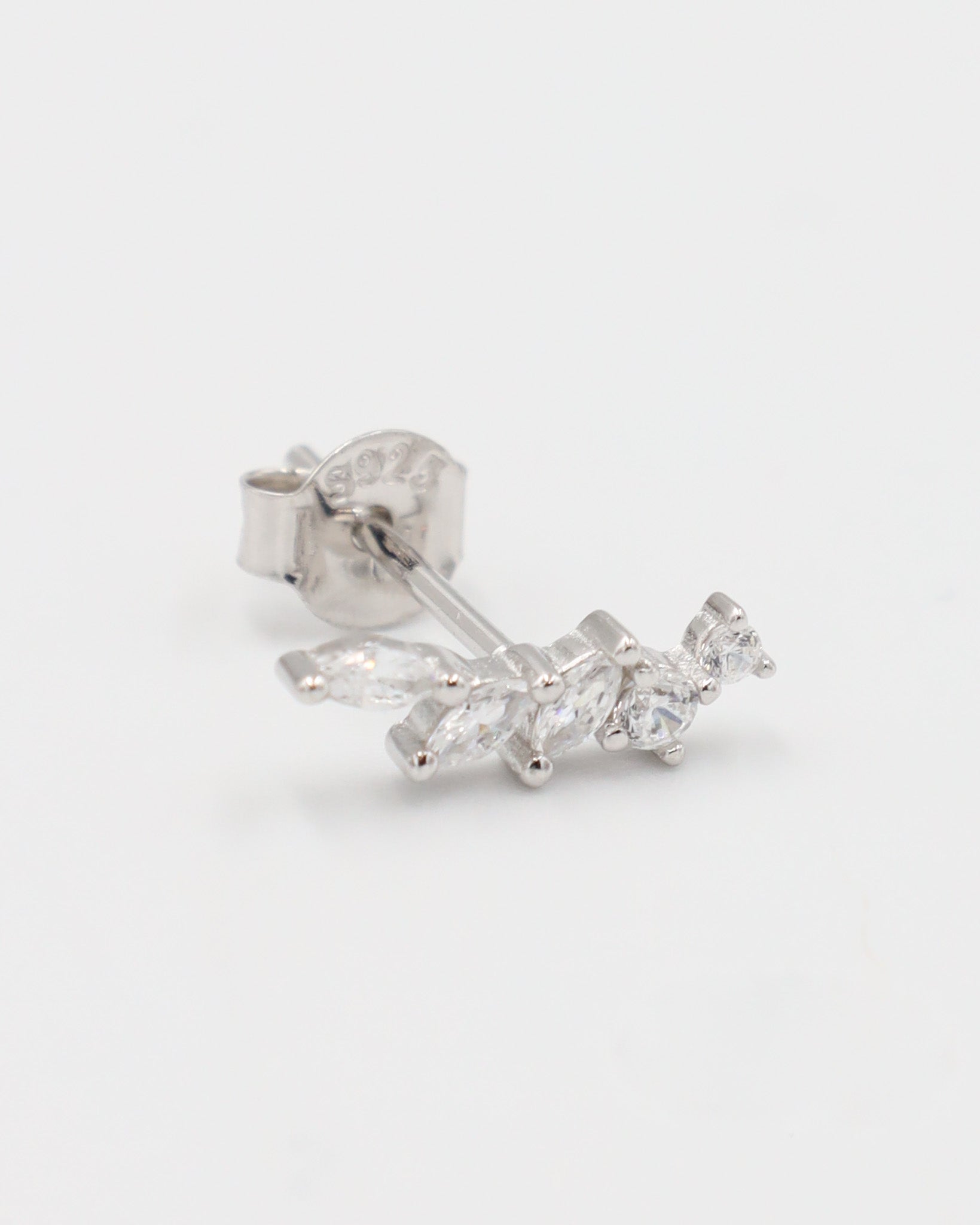 A pair of silver stud earrings with a butterfly clasp, featuring a intricate pattern.